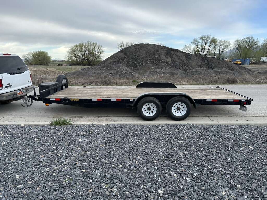 20 foot flatbed car hauler with dual axles and ramps stowed flat